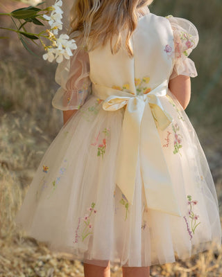Girl in floral embroidered tulle dress from Faeella twirling in garden, perfect for keepsake photoshoots and outdoor party. Most comfortable and lightweight party dress for toddlers and girls