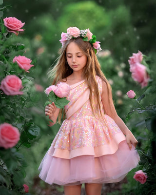 Little girl in Faeella Rosy Bloom Off - Shoulder Sequin Party Dress in garden. Perfect for birthday and holiday photoshoots, best party outfit for special occasions