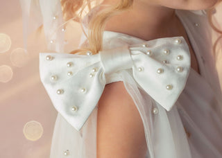 Close-up of pearl-embellished satin shoulder bow on Faeella Stardust Embroidered White Tulle Party Dress