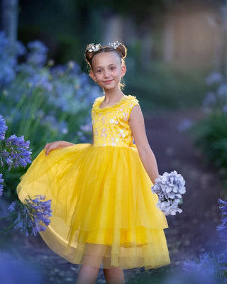 Girl in yellow floral embroidered tulle dress holding flowers for Faeella, perfect for spring photoshoot, birthday, party and everyday play