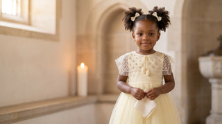 Buttercream pearl-capelet Faeella christening dress in a sunlit chapel — small batch christening dress
