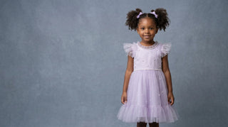 Lilac pearl-scatter Faeella picture day dress on a slate-blue studio backdrop — small batch occasion dress