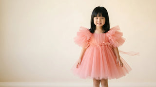 Coral organza pleated Faeella tulle dress mid-twirl, editorial studio — small batch occasion dress