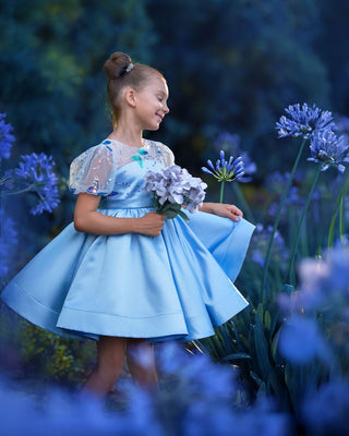 Girl wearing blue butterfly sequin, Faeella Celestial butterfly dress in magical garden, perfect for holiday party, birthday parties, wedding and flower girl.