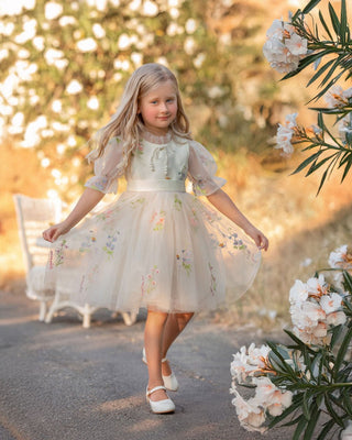 Girl in floral embroidered tulle dress from Faeella twirling in garden, perfect for keepsake photoshoots and outdoor party. Most comfortable and lightweight party dress for toddlers and girls