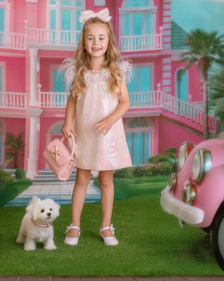 Girl in sparkly pink sequin dress holding puppy. Perfect comfortable dress for whole day event like birthday party or holiday celebration.