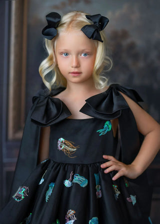 Hand-applied black sequin bodice fabric detail closeup of Faeella girls birthday dress