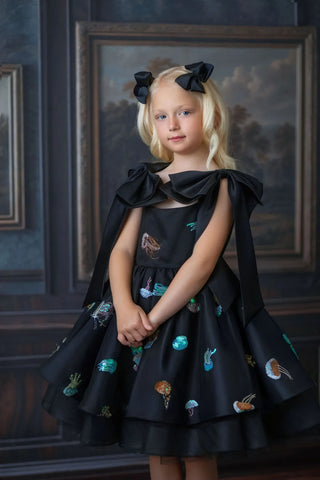 Girl wearing black sequin tulle birthday dress in lifestyle photo by Faeella